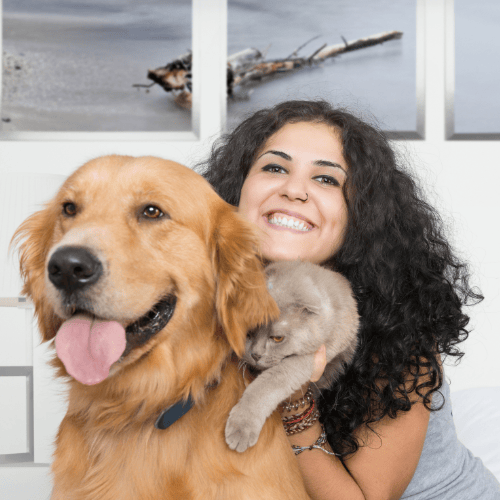 A lady with her cat and dog